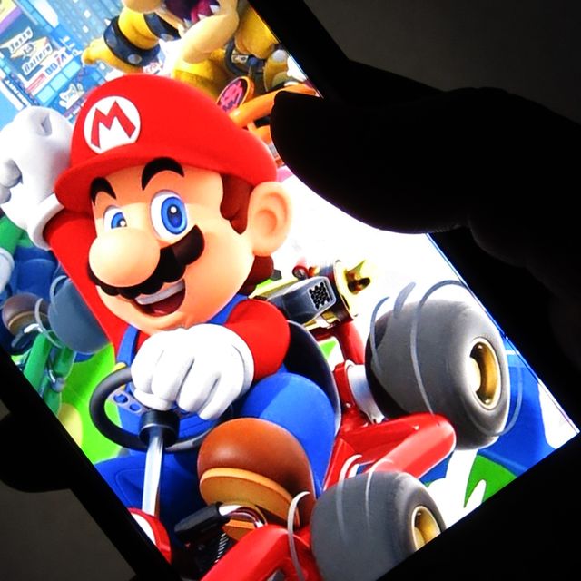 a woman shows the title mario kart tour on her smartphone during game center in tokyo, japan september 26, 2019 after over a year of waiting mario kart tour is now finally available to download on ios and android, making this only the third mario title on mobile                photo by hitoshi yamadanurphoto via getty images