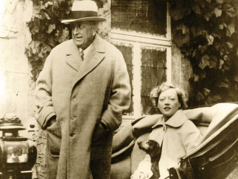 marion davies and william randolph hearst in bad nauheim, germany, davies’s pet dachshund peeks his nose out from her coat