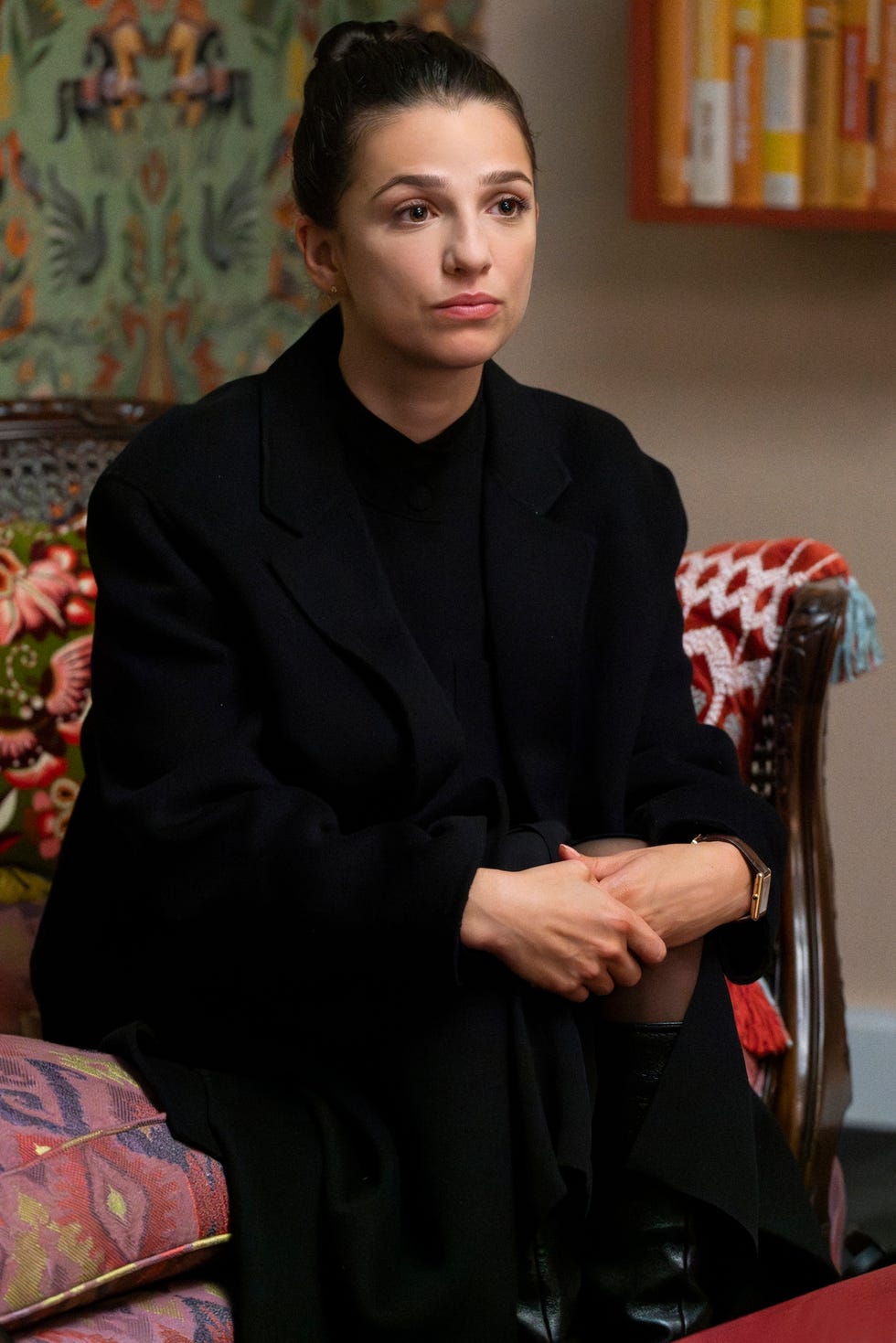 a woman dressed in black sitting down