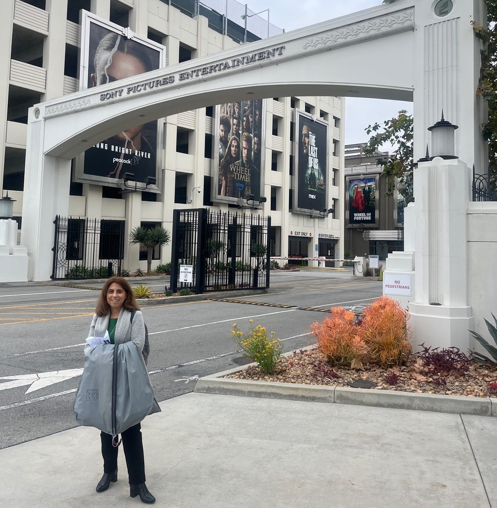 entrance to sony pictures entertainment with a person holding a gray bag