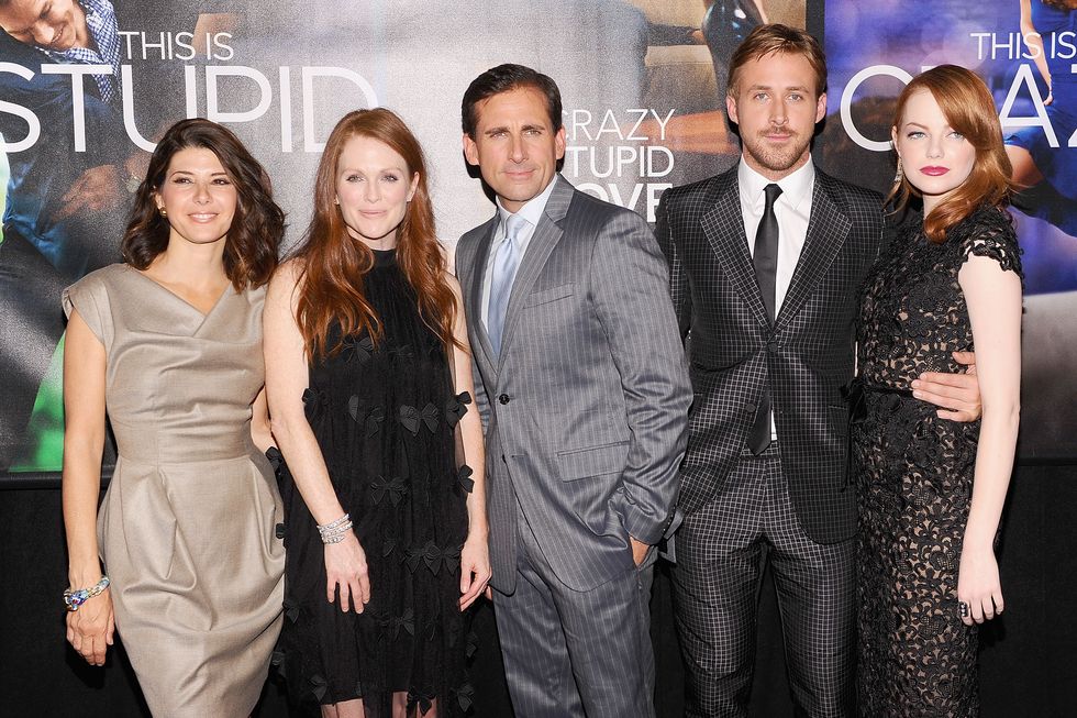 marisa tomei, julianne moore, steve carell, ryan gosling, and emma stone stand in front of a movie poster and pose for photos