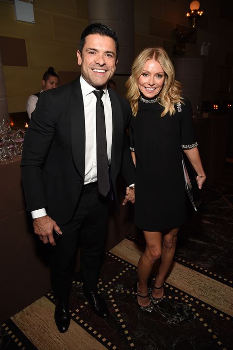 mark consuelos and kelly ripa holding hands while attending event
