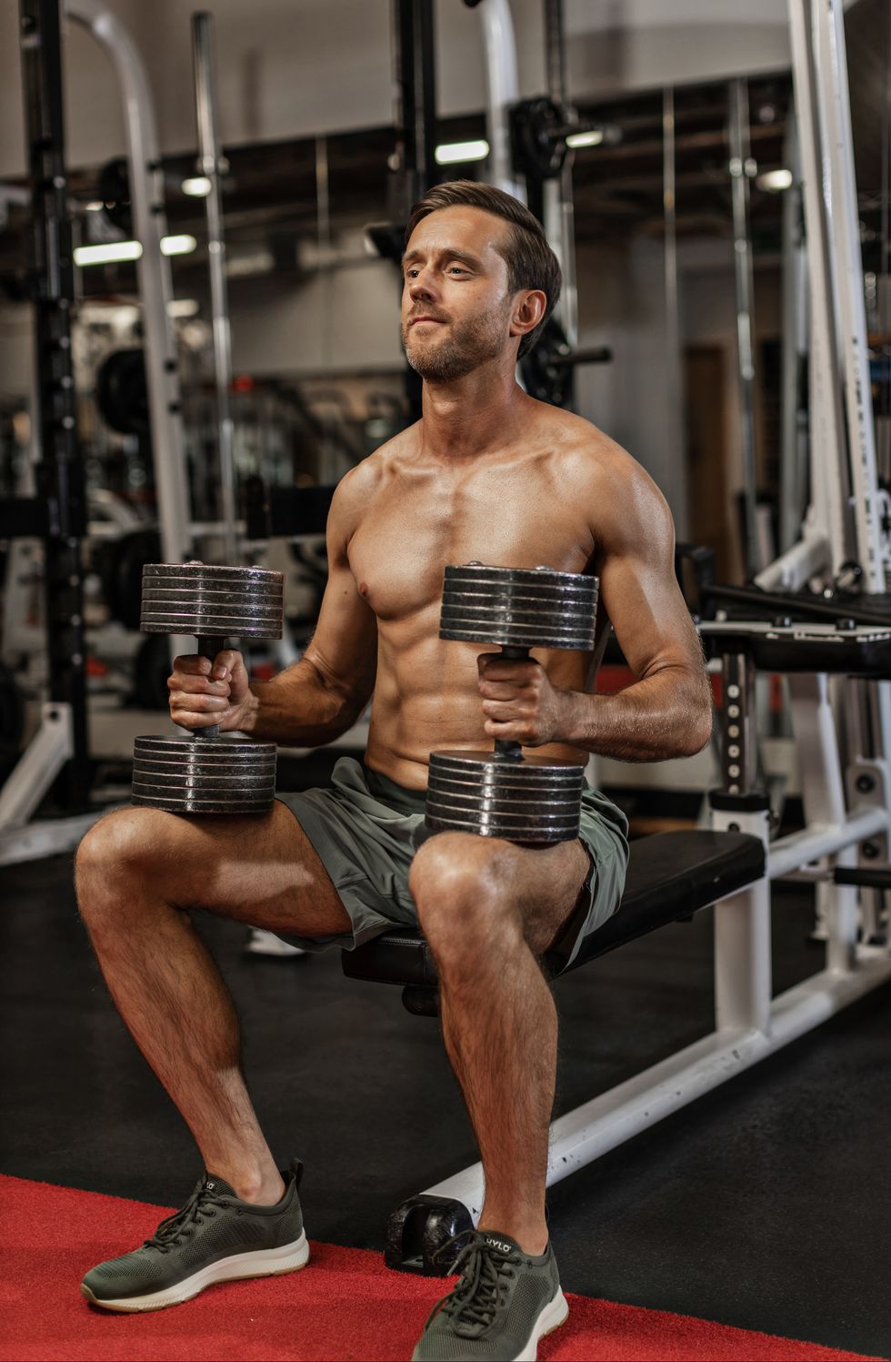 sitting down holding two dumbbells