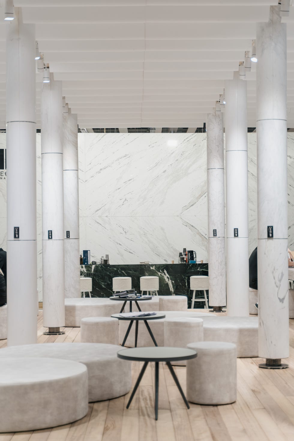 a room with white pillars and tables