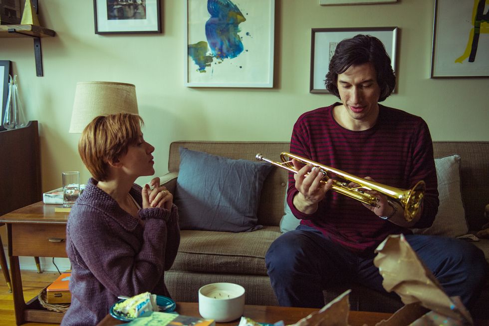 adam driver holding a musical instrument in a scene from the movie marriage story