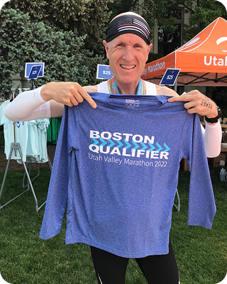 a person holding a boston qualifier tshirt