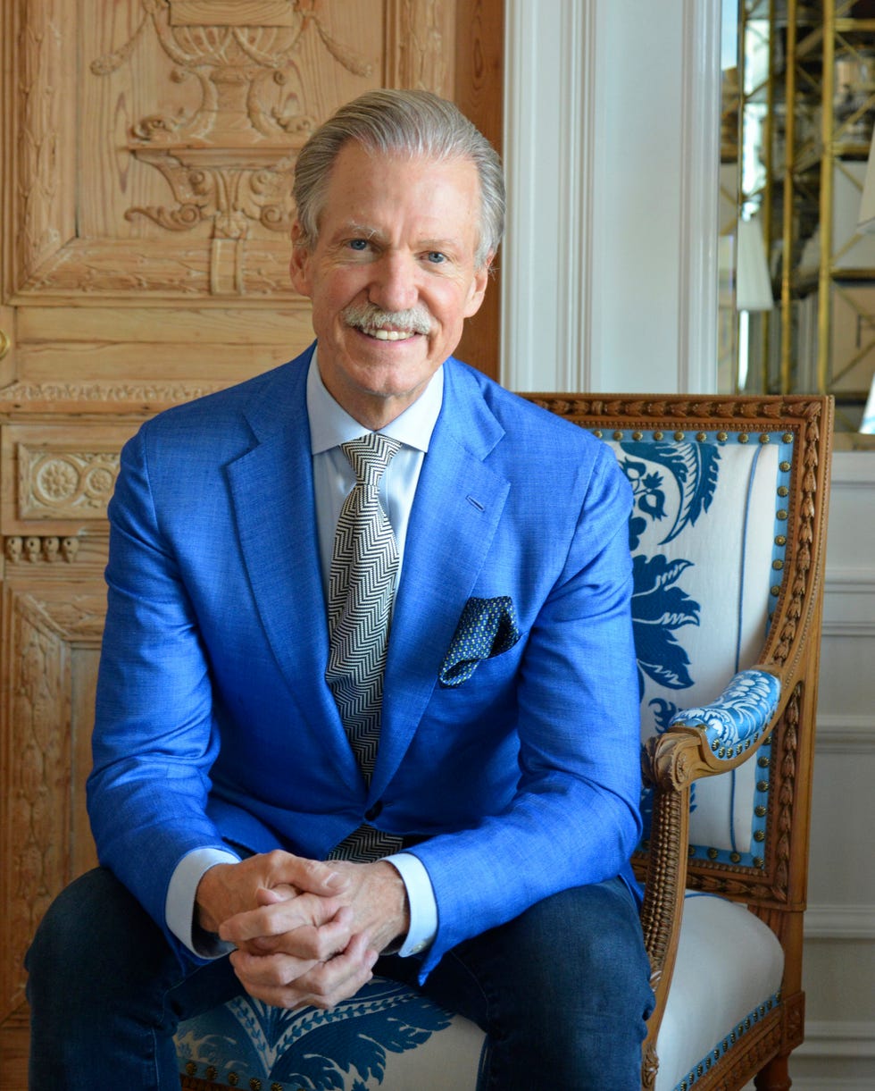 designer marshall watson in a tie and blue jacket seated in a chair