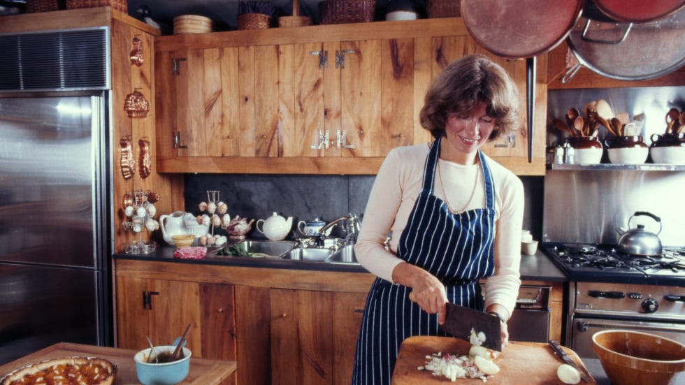 a person chopping vegetables in a rustic kitchen
