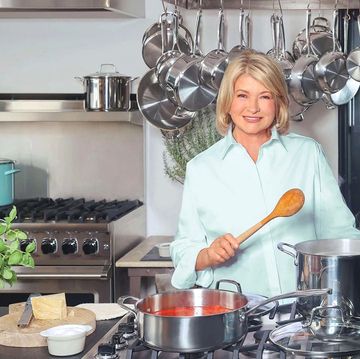 martha stewart cooking in kitchen with stainless steel and blue cookware