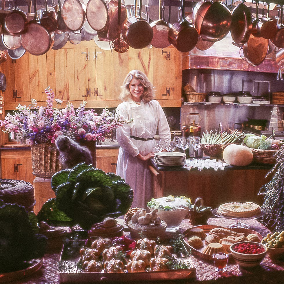 a busy kitchen scene with various dishes and ingredients displayed on a table