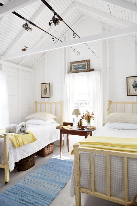 a kick back kind of cottage martha’s vineyard retreat homeowners phoebe cole smith and mike smith guest bedroom, fishing rods