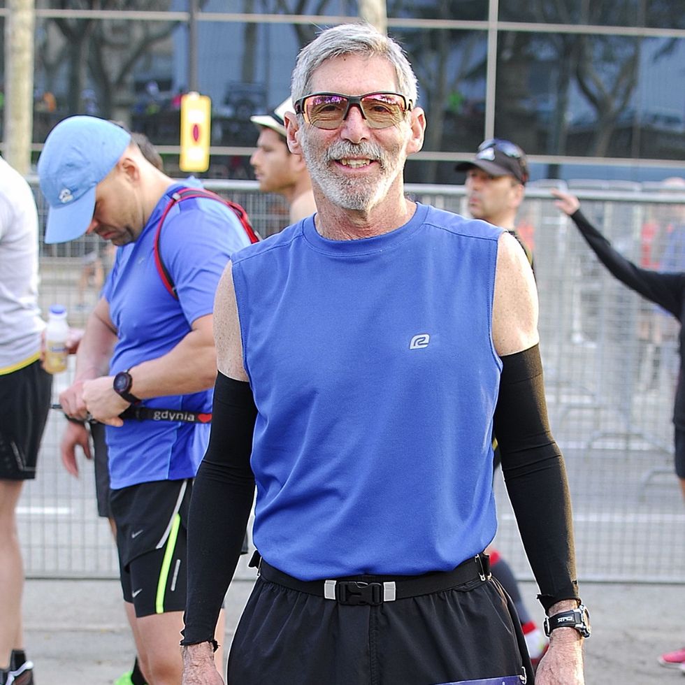 a man smiling for a photo before a running race