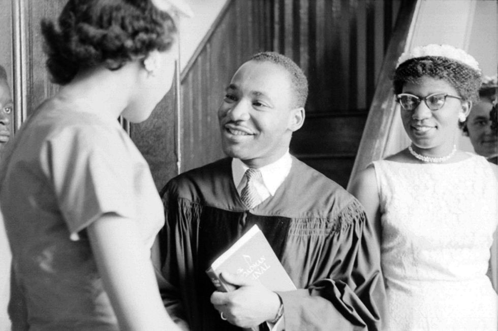 Reverend Martin Luther King, Jr. speaks with people after delivering a sermon on May 13, 1956 in Montgomery, Alabama.