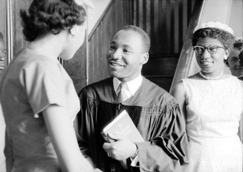 Reverend Martin Luther King, Jr. speaks with people after delivering a sermon on May 13, 1956 in Montgomery, Alabama.