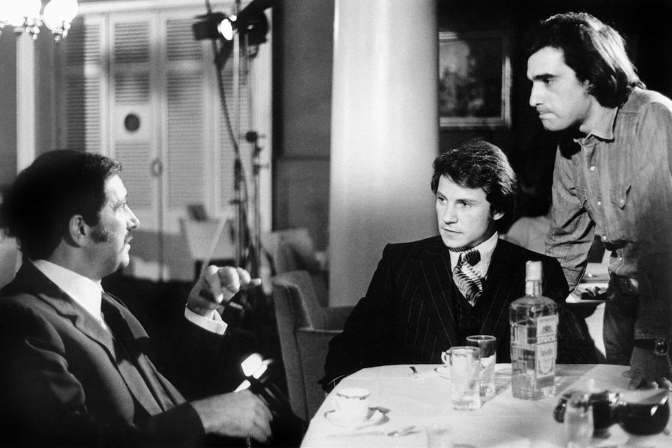 a black and white photo of martin scorsese directing cesare danova and harvey keitel on the set of the film mean streets