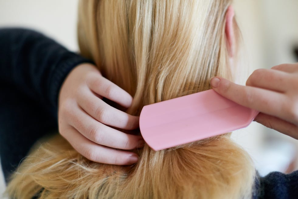 woman combing hair with marula oil