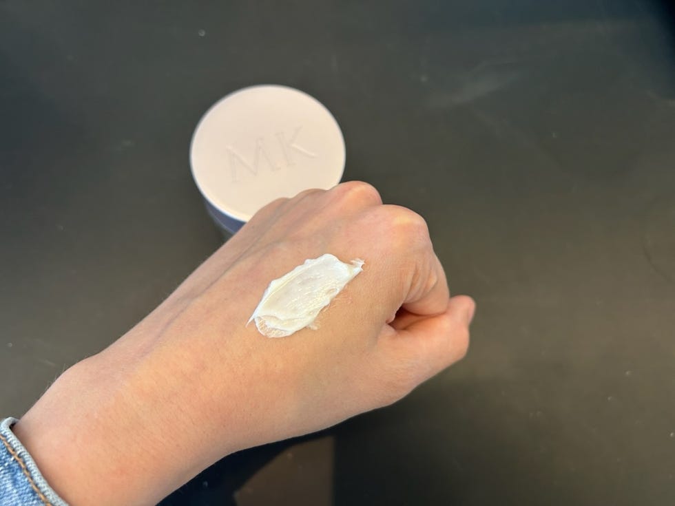 a photo of a lab scientist testing a mary kay neck firming cream in the good housekeeping institute