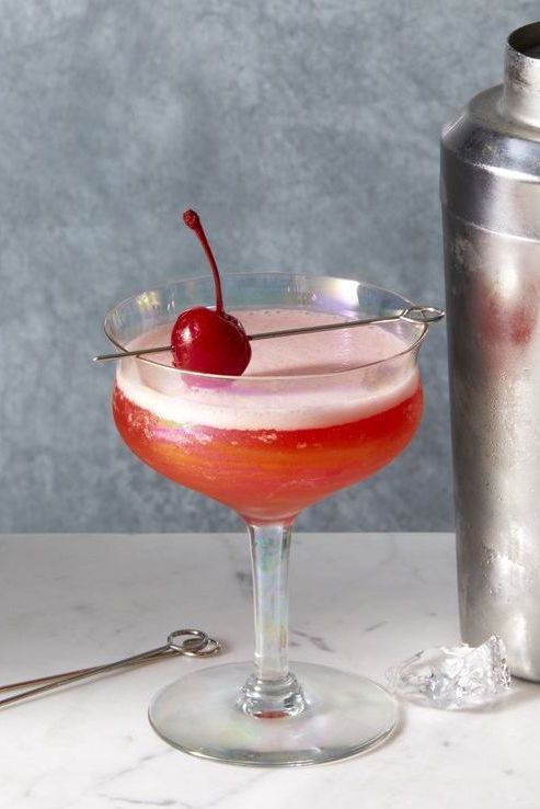 a pink mary pickford cocktail with a cherry on top