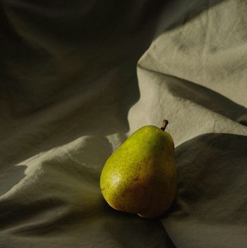 a green fruit on a blanket
