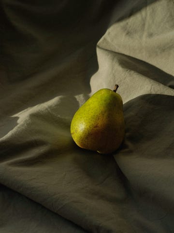 a green fruit on a blanket