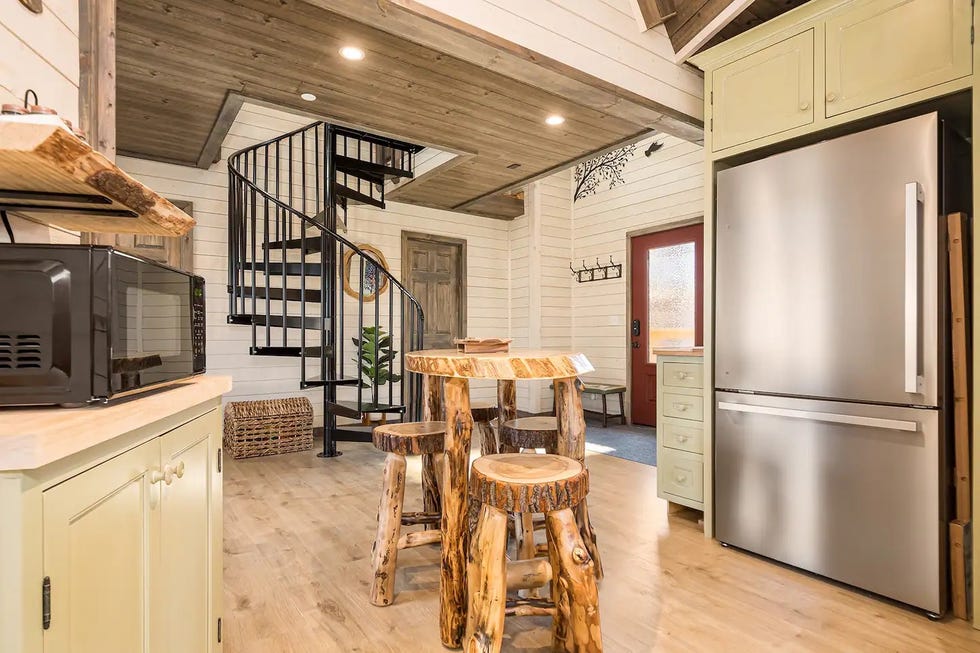 a kitchen with a table and chairs