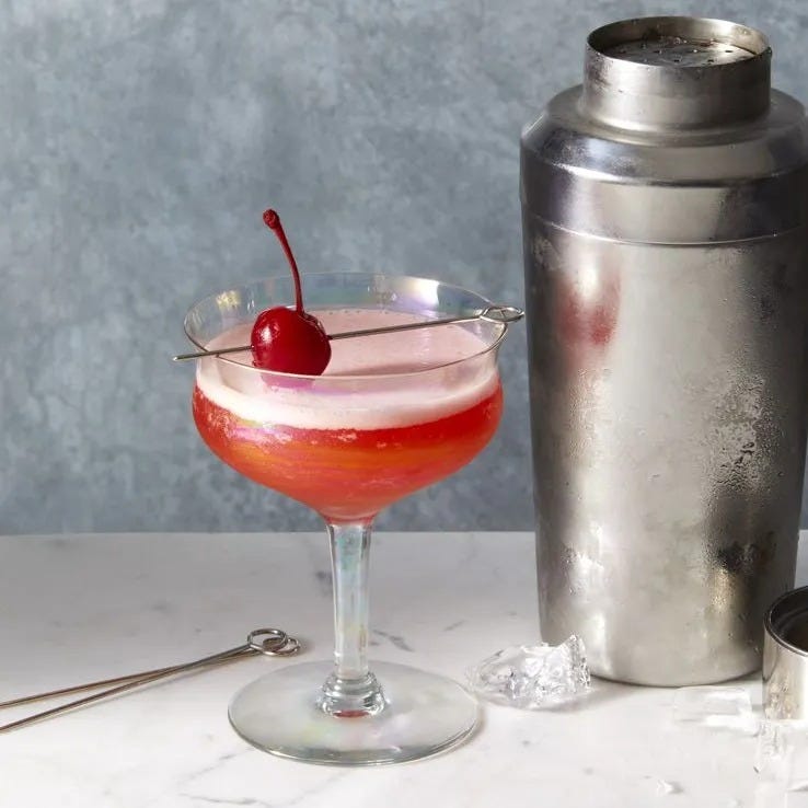 a pink mary pickford cocktails with a cherry on top