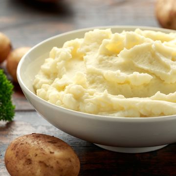 mashed potatoes in white bowl on wooden rustic table 
healthy food