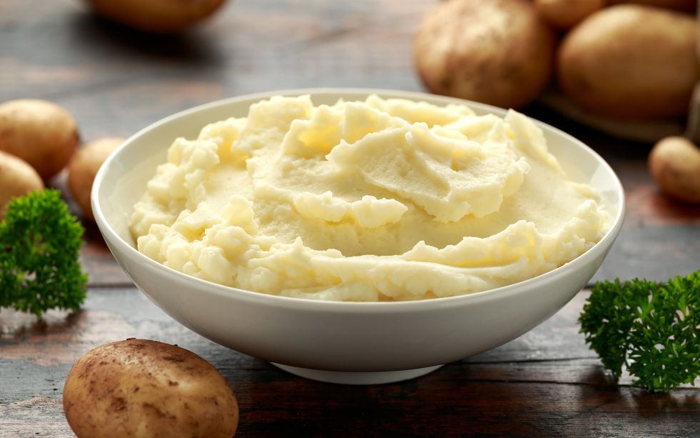 mashed potatoes in white bowl on wooden rustic table healthy food