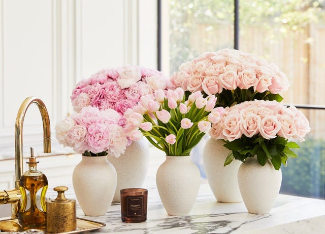 arrangement of fresh flowers in vases on a countertop