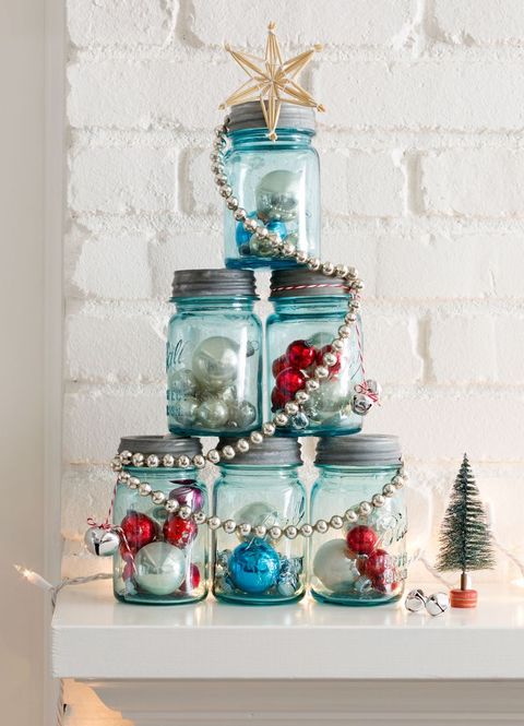 a set of 6 mason jars stacked to resemble a tree shape and each is filled with christmas ornaments