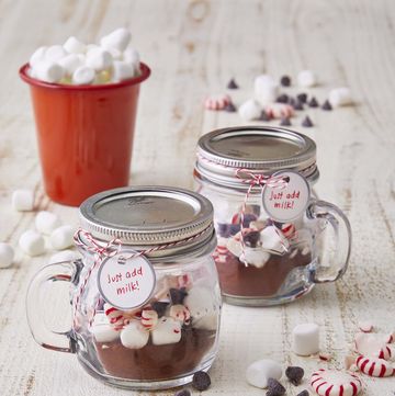 hot chocolate mix in mini mason jar mugs on a white table