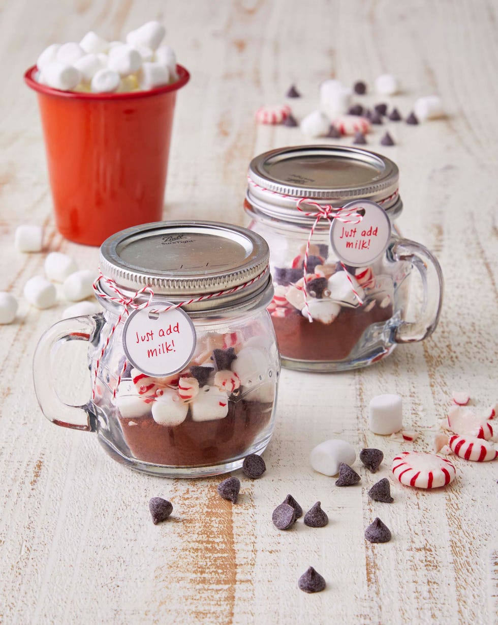 hot chocolate mix in mini mason jar mugs on a white table