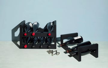 black wine racks displaying bottles with colorful caps