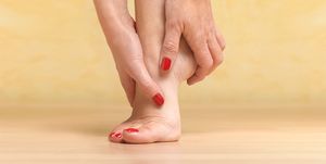 massaging sore foot