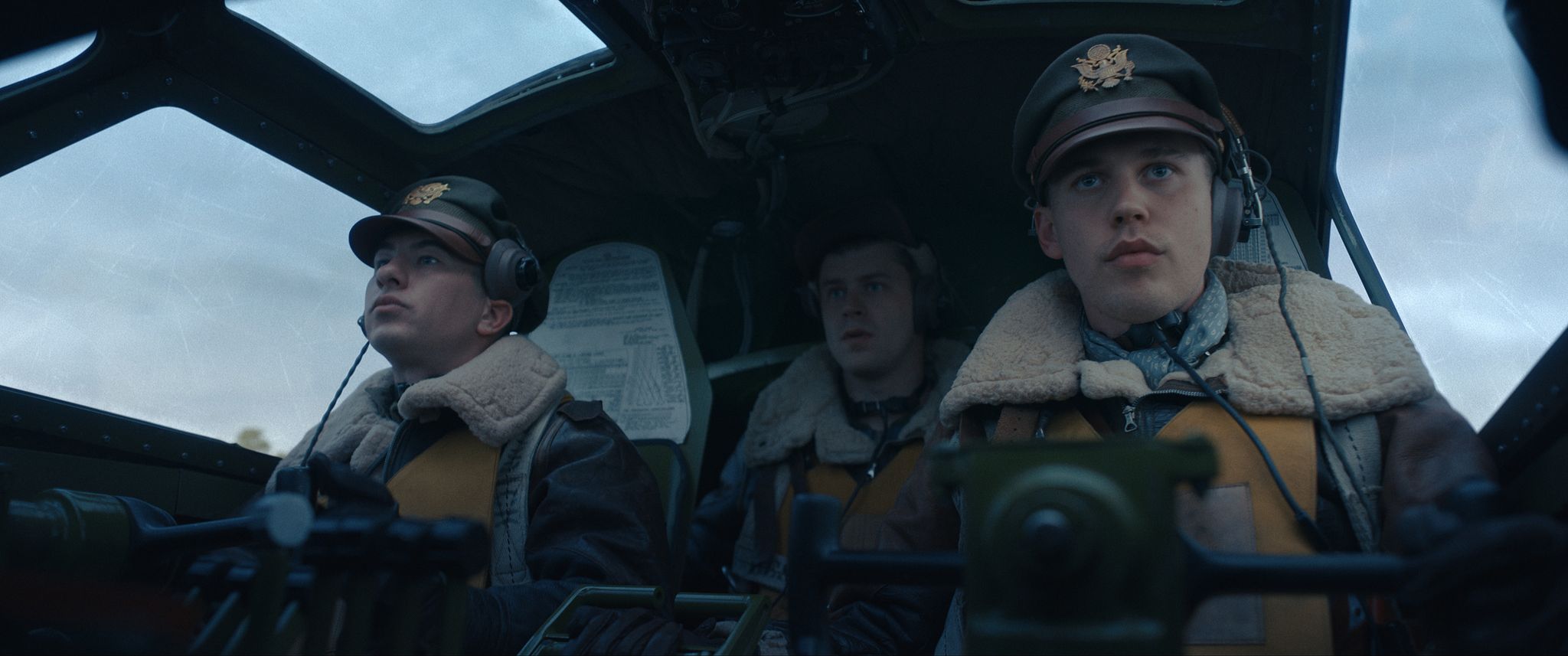 a group of people in military uniforms in a cockpit