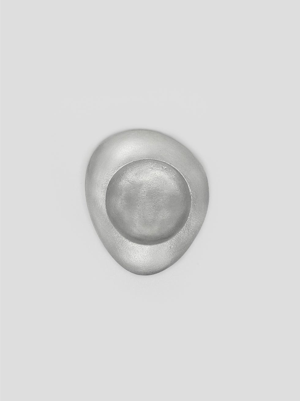 circular metallic object with a recessed square area