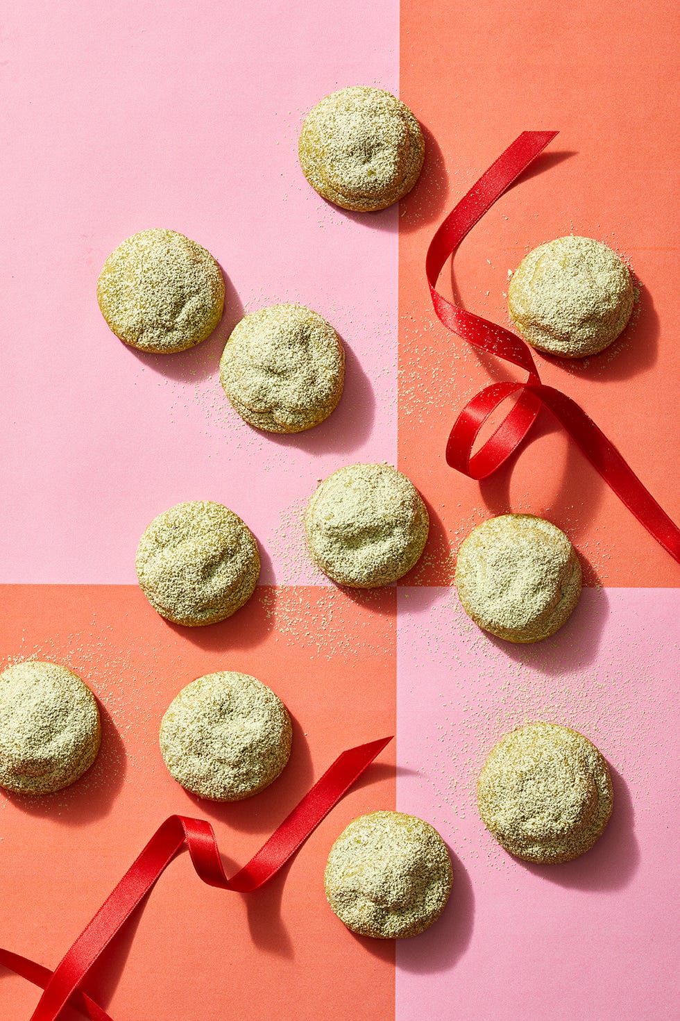 matcha snowball cookies on a festive pink and red background