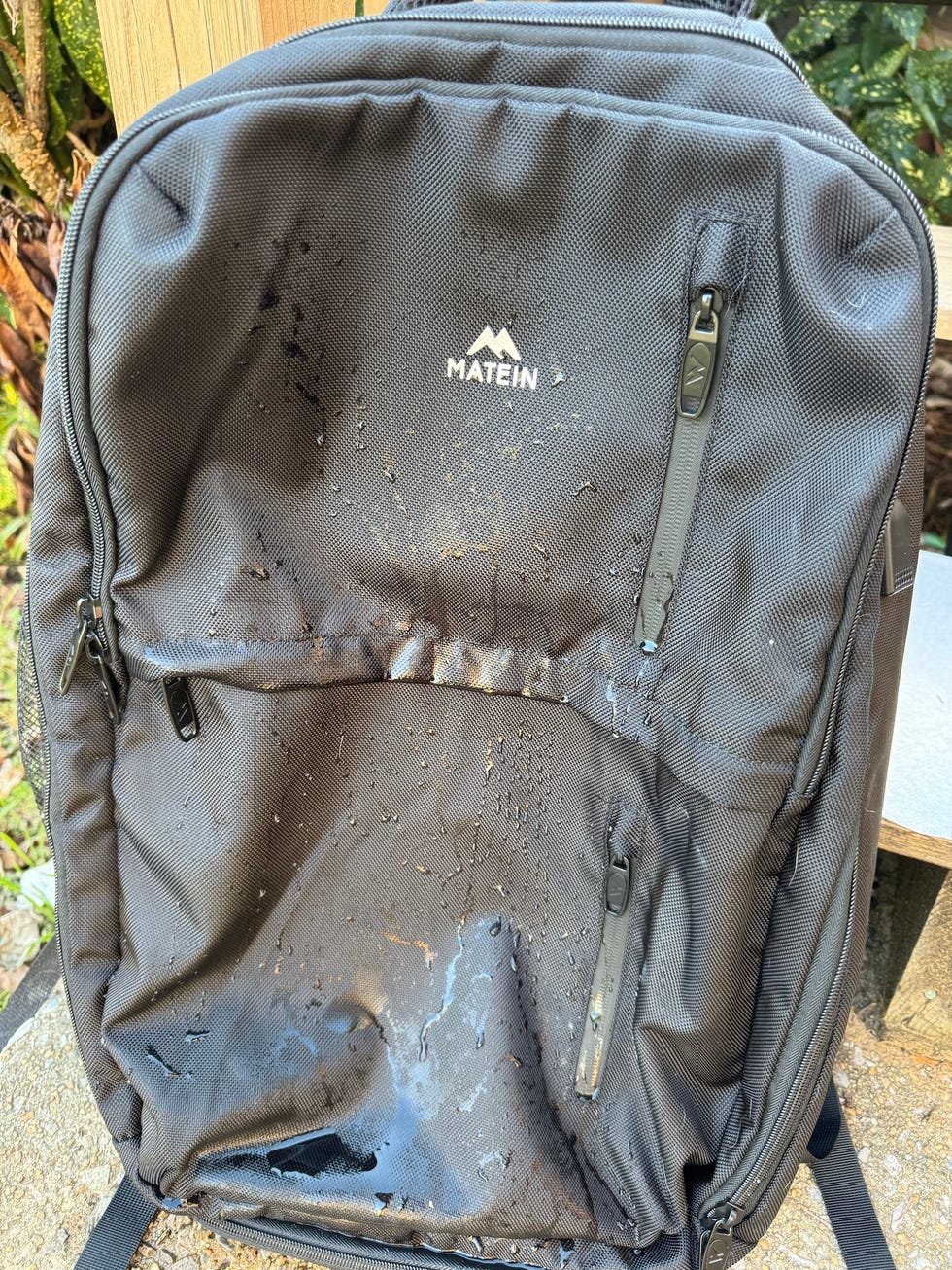 a black backpack showing signs of water damage