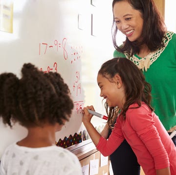 pupil writing on the board at elementary school maths class for math jokes