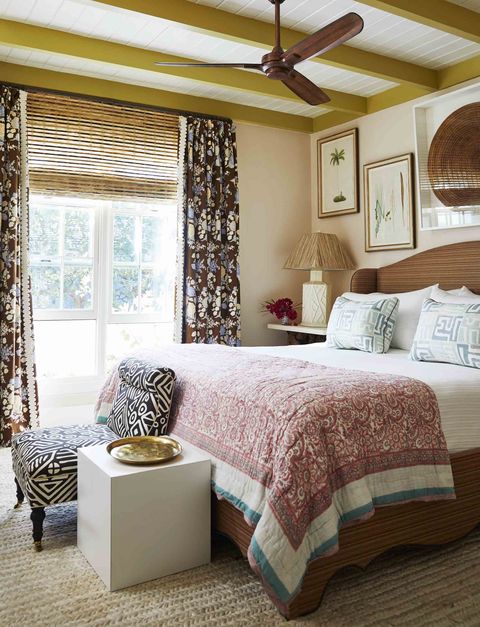master bedroom beams are painted a brilliant chartreuse and the bed linens and window coverings are full of pattern