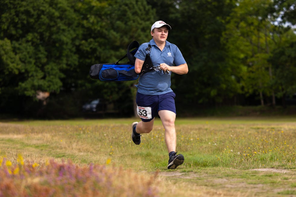 male speedgolfer running on a golf course