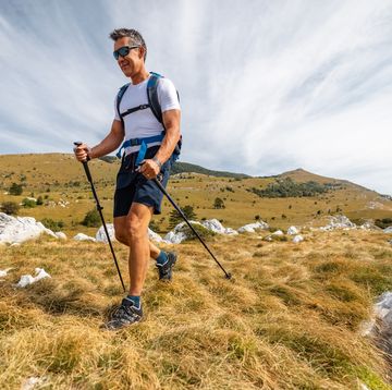 mature adult asian hiking in the mountains