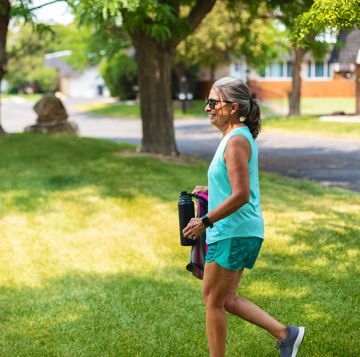mature adult female walking through a park setting photo series