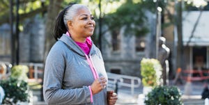 Mature African-American woman jogging in city