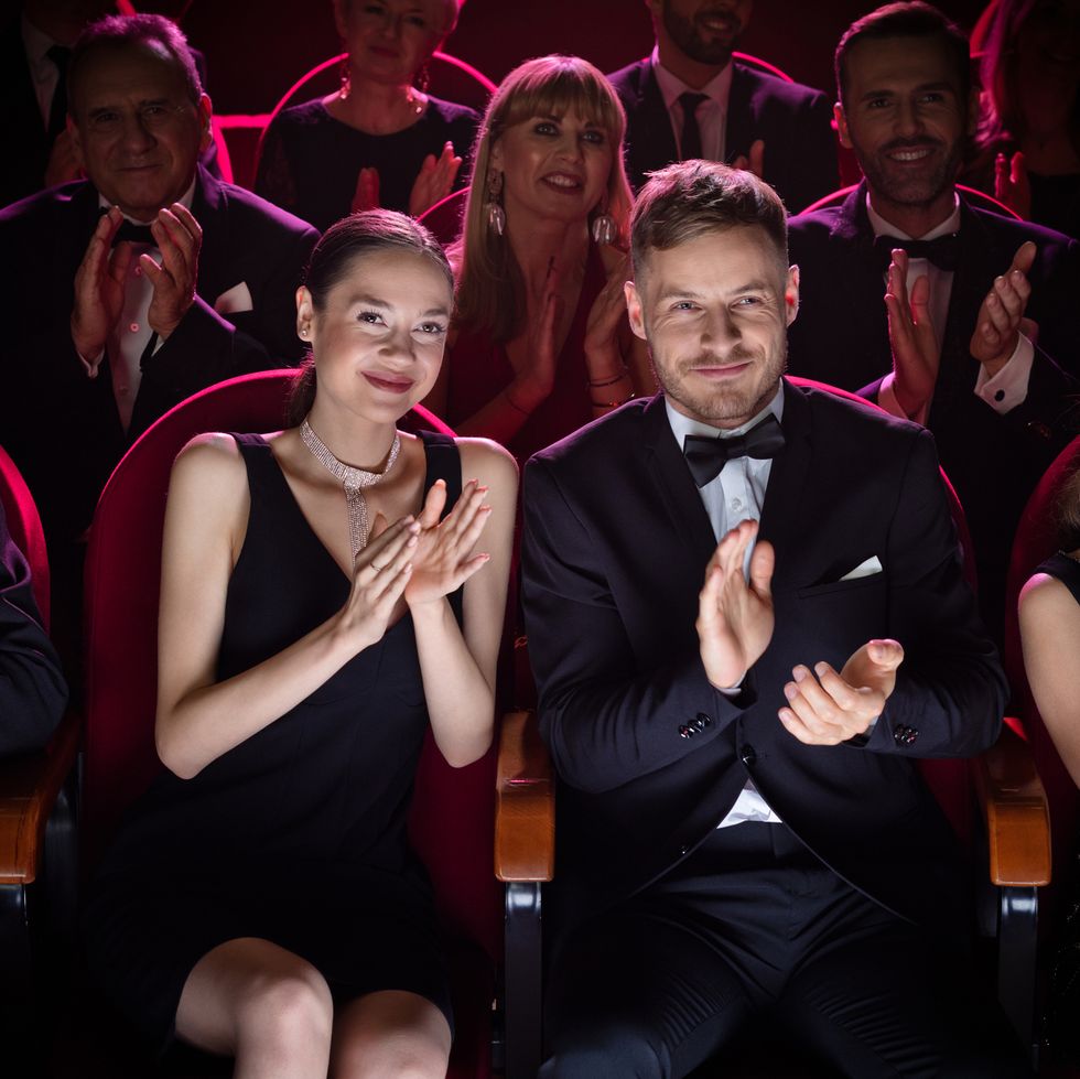 mature couple clapping while watching opera