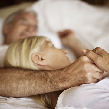 mature couple embracing in bed