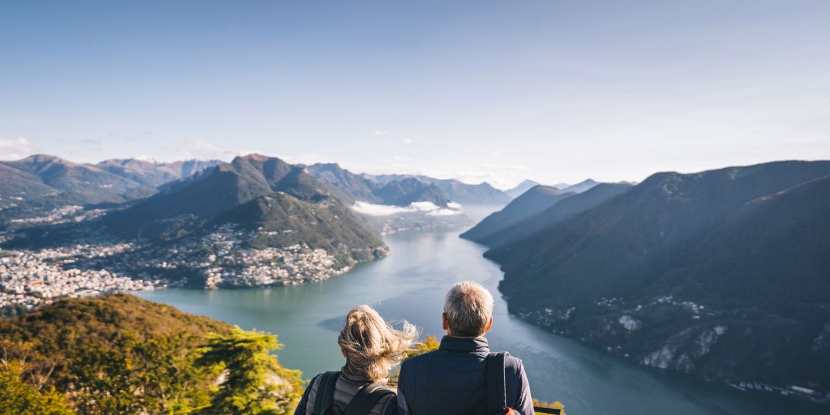 https://hips.hearstapps.com/hmg-prod/images/mature-couple-hike-above-lake-lugano-in-the-morning-royalty-free-image-1641254420.jpg?crop=1.00xw:0.752xh;0,0.250xh&resize=1200:*