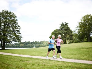 mature couple running in nature