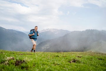 mature male backpacker hiking on mountain