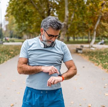 mature man checking his fitness progress on smartwatch